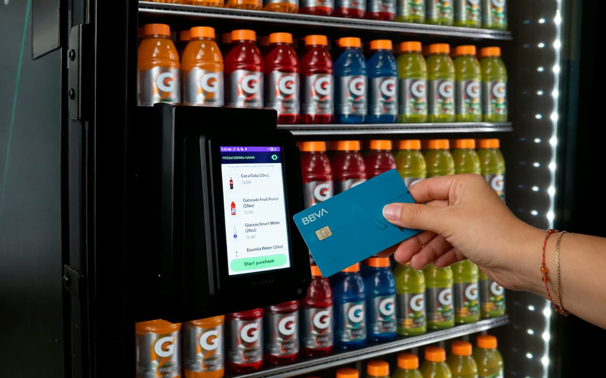 A shopper taps a card to unlock an A-POP stocked with sports drinks